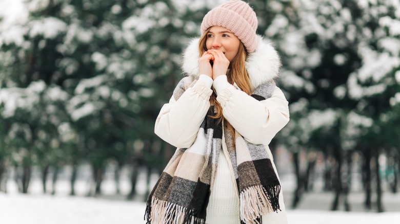 woman dressed in hat, scarf and winter jacket