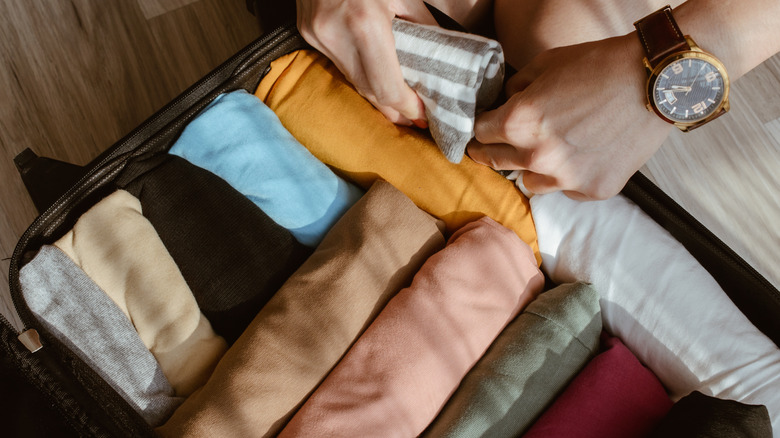 Rolled clothes in suitcase.