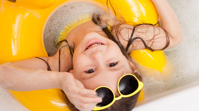 girl with inflatable bath toy
