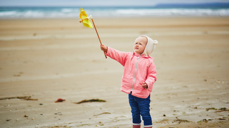 toddler girl with pinwheel