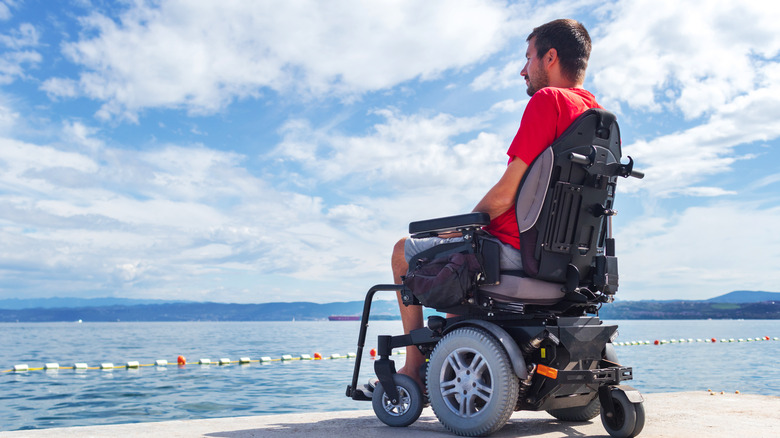 a man in an ECV looking at the ocean