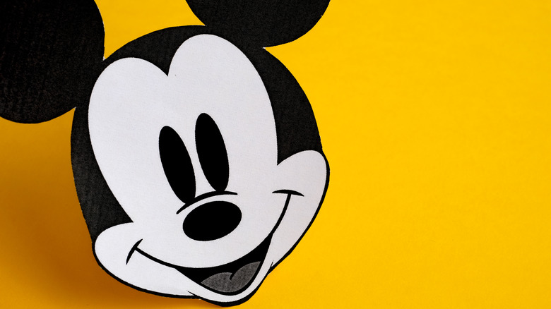 Mickey Mouse's face in front of a yellow background