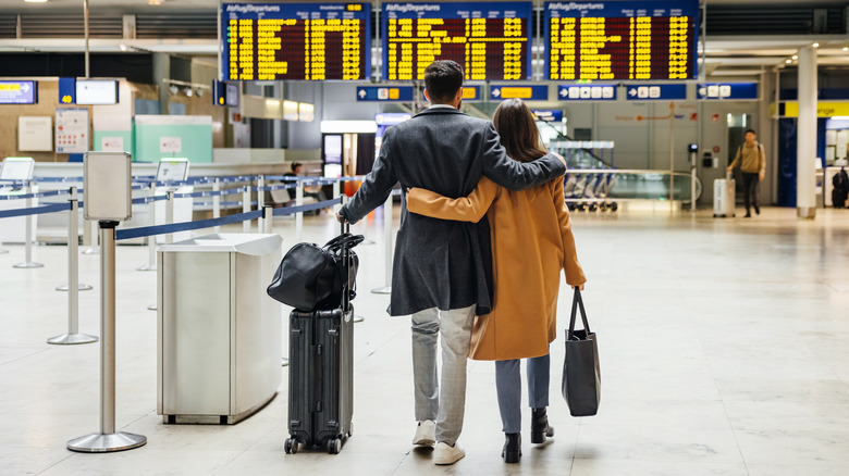 couple walking through airport together