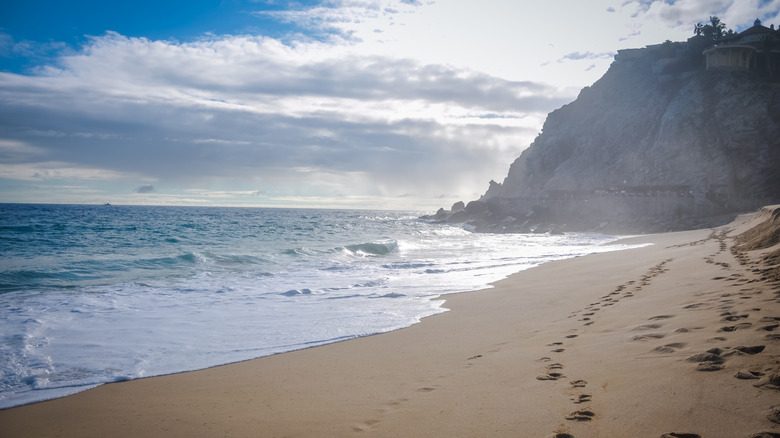 Footprints on the sand at Playa Solmar in Cabo San Lucas, Mexico