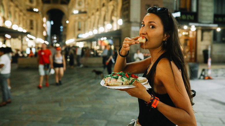 Traveler eating pizza in Italy
