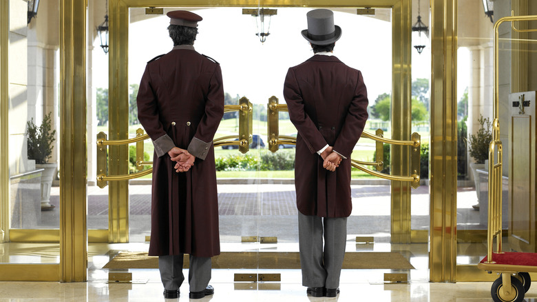 Two hotel porters waiting door