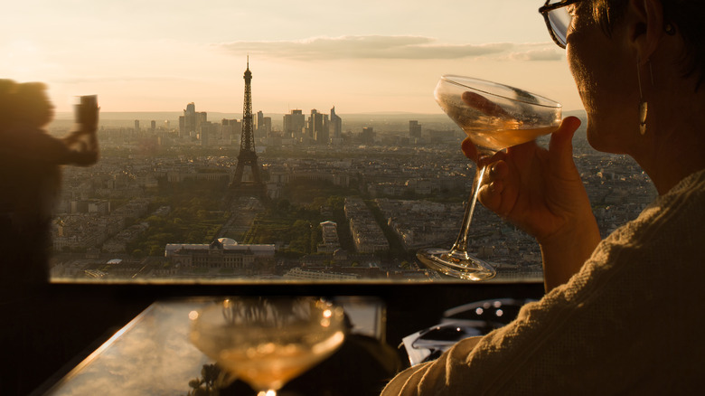 Traveler enjoying a drink overlooking the Eiffel Tower