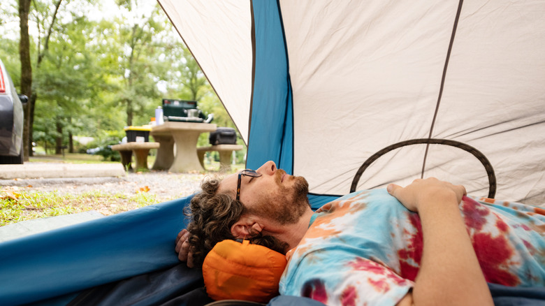 man sleeping in tent