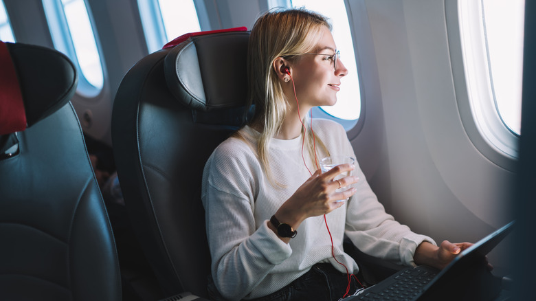 woman happily sitting in window seat