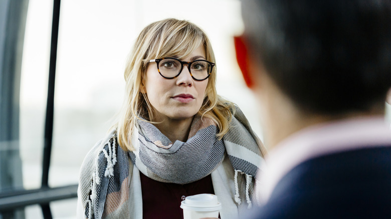 Woman looks skeptically at man