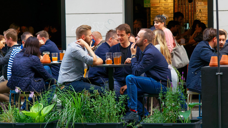 people at outdoor bar table