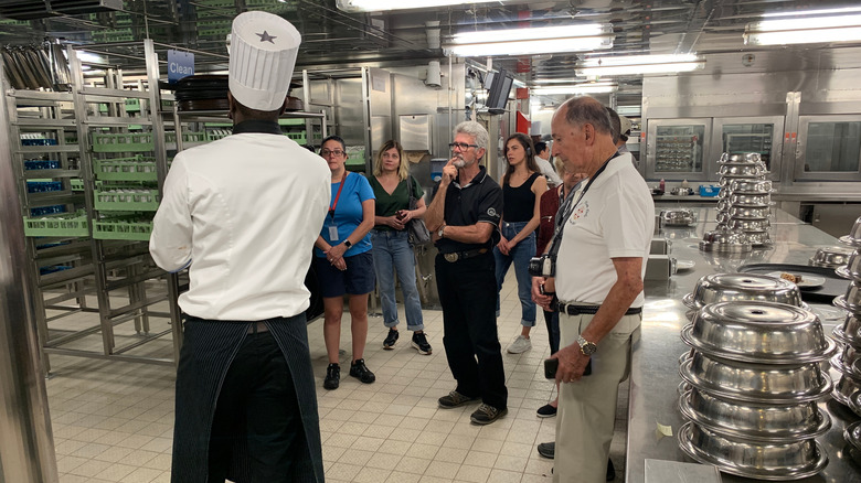 Passengers touring cruise ship galley