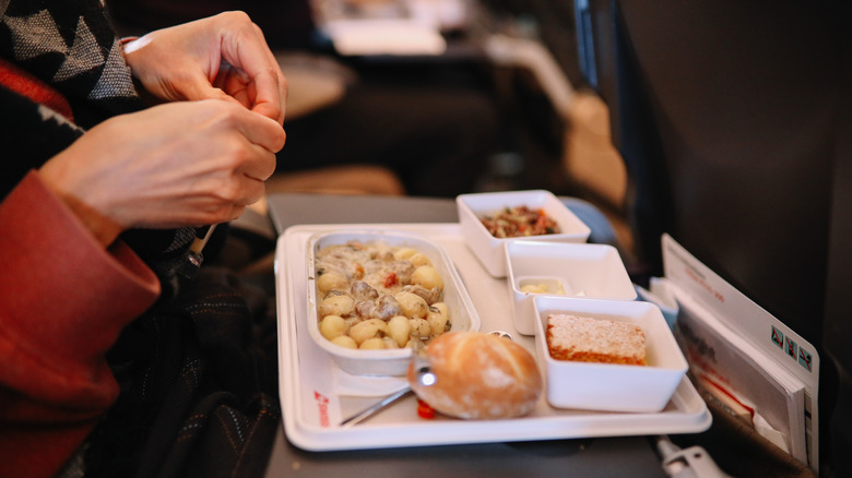 Woman eating an airplane meal