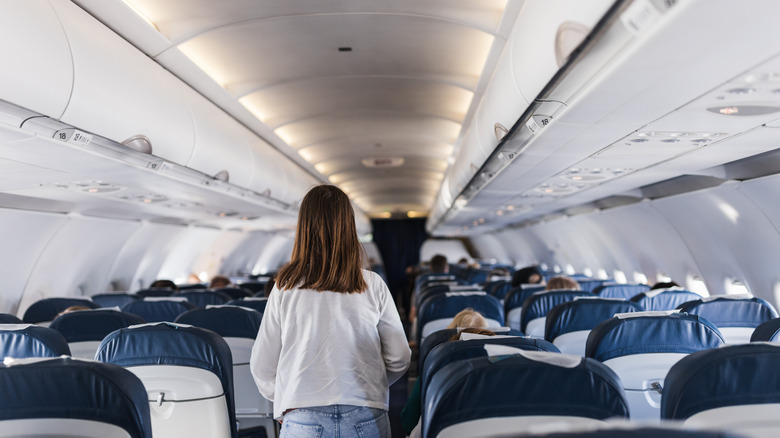 Woman blocking passageway on flight