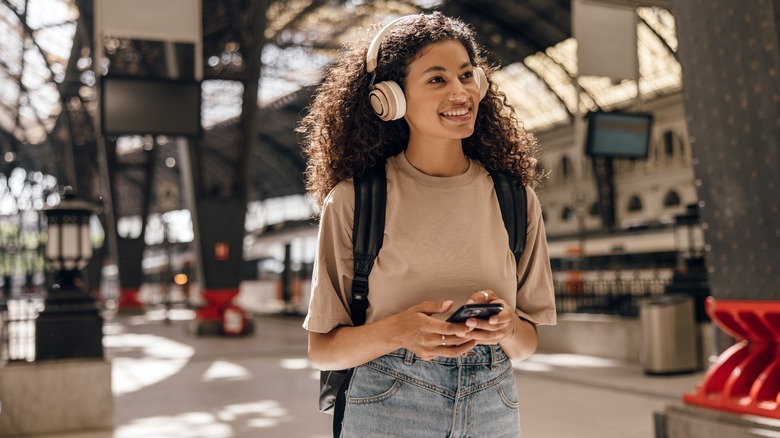 smiling tourist wearing headphones