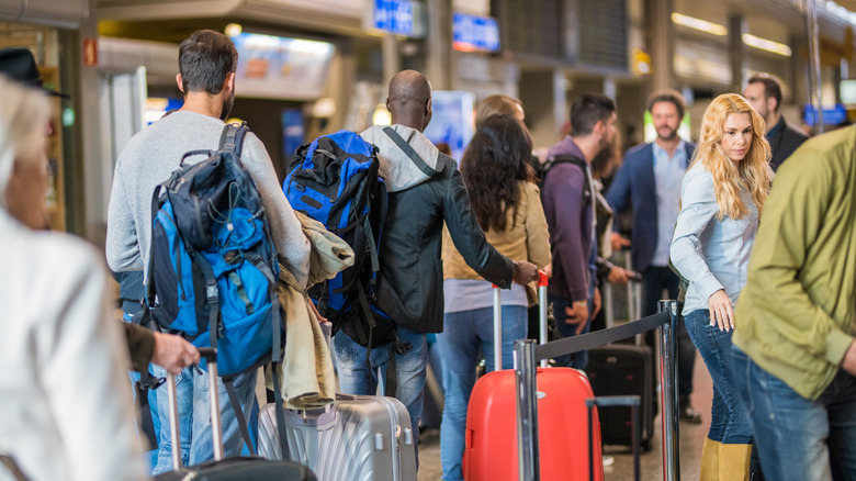 A long line of passengers at check-in.