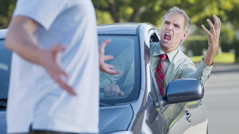 Driver yells at pedestrian in front of car