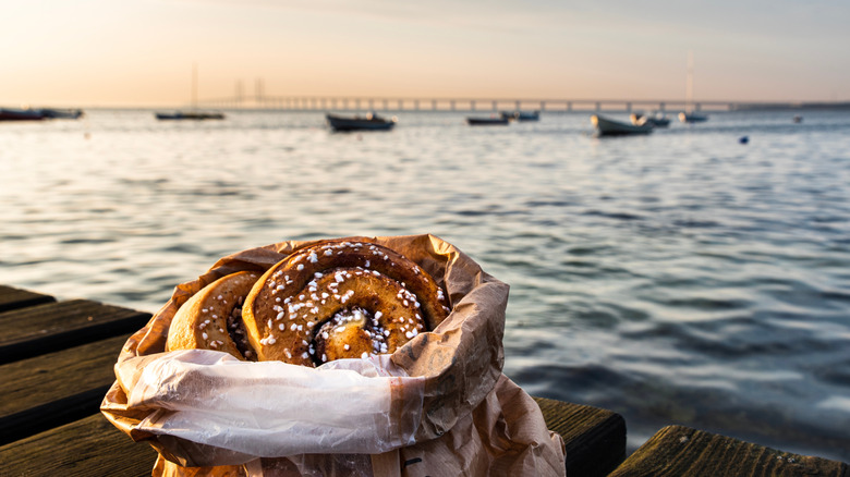 A bag of cinnamon rolls by the water in Sweden.