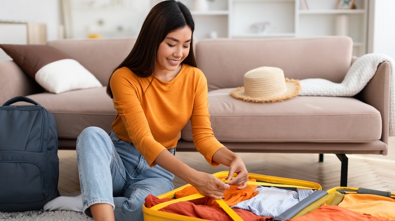 woman packing suitcase