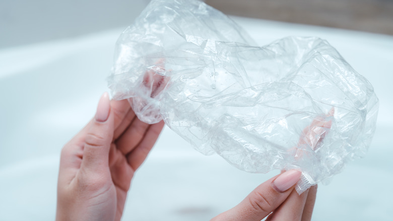 Hands holding a shower cap