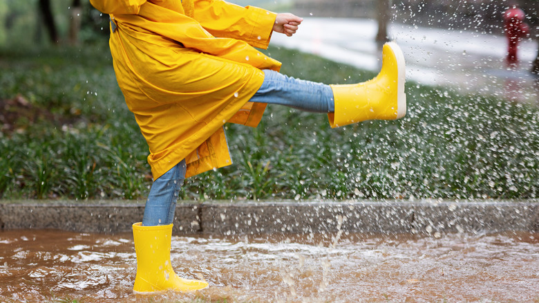 Woman splashing in rain