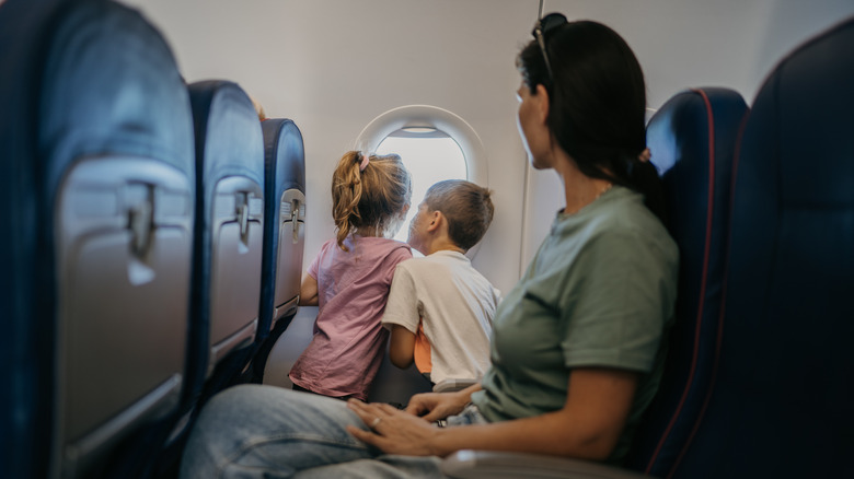 children looking out of plane window