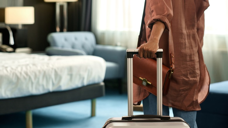 Traveler standing in hotel room