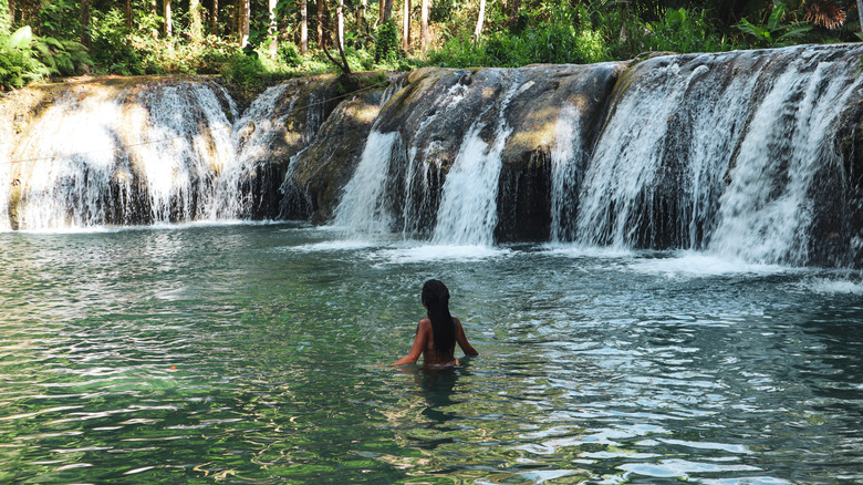 girl swimming in waterfalls 