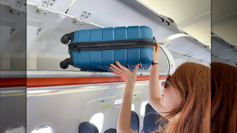 carry-on luggage in overhead bin