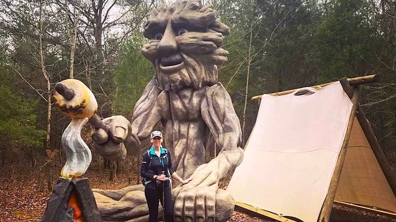 Wooden sculpture near makeshift tent