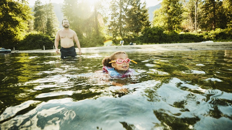 Parent watching child swim 