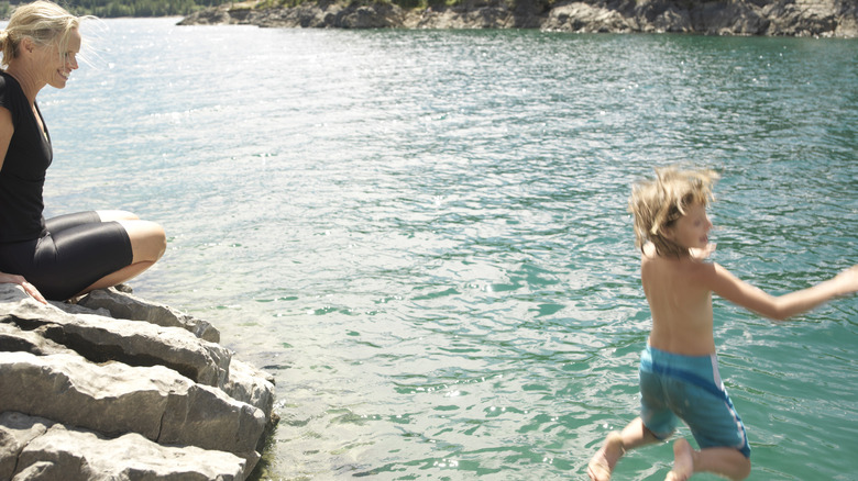 Woman watching child swim