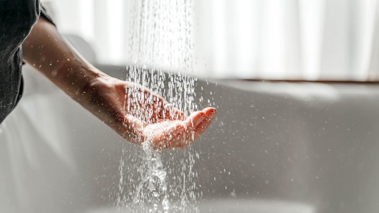 Person's hand under running water