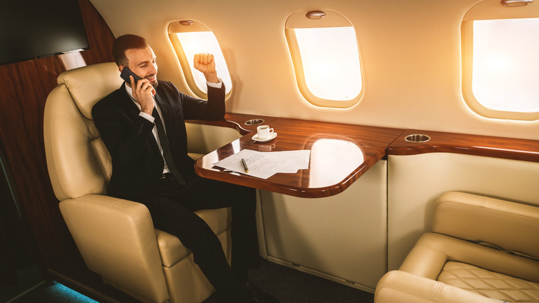 man traveling business class on flight