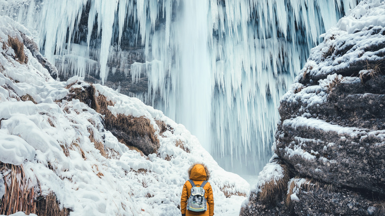 Peričnik Waterfall frozen with hiker