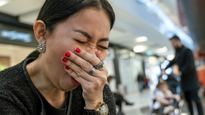 woman at airport yawning