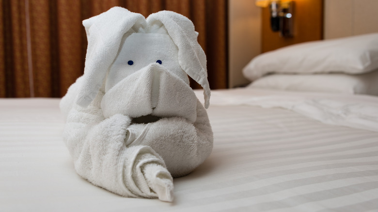 rabbit-folded towel on hotel bed 