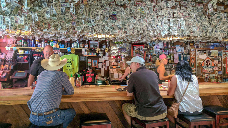 Patrons seated at wooden bar in Napa