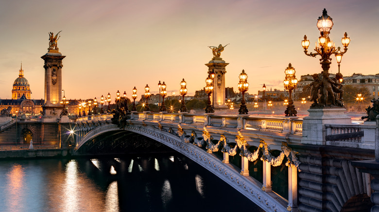 Paris Alexandre III bridge with lit streetlights