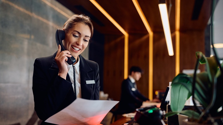 Woman on phone at hotel reception