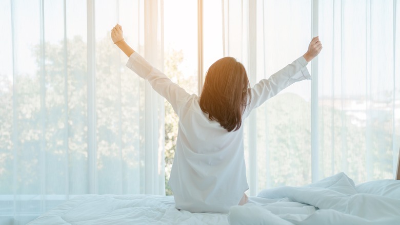 Woman stretching after good sleep