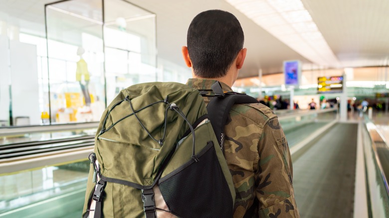 Serviceperson on airport walkway