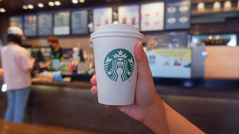 Person holding a Starbucks cup