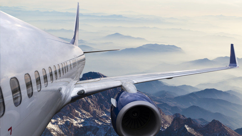 airline flying over mountains