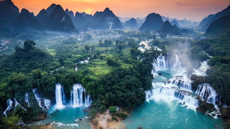 Water pours down Ban Gioc-Detian Falls in Vietnam at sunset