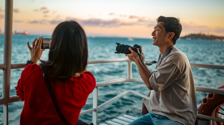 A couple taking photos on ship