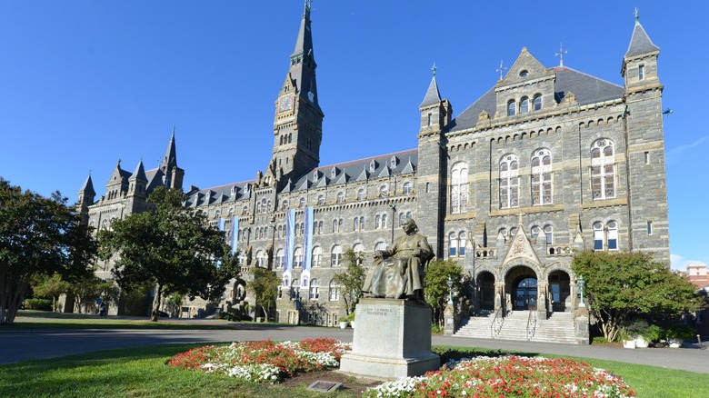 statue and building on the Georgetown University campus