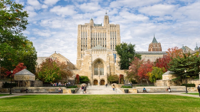 student walking across Yale's campus