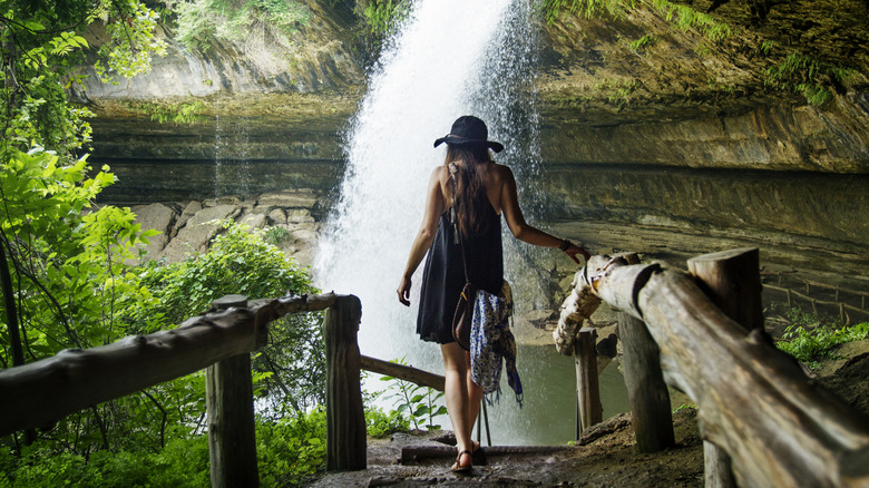 Walking behind waterfall, Texas