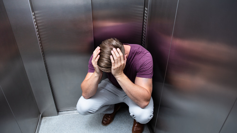 Scared man in elevator